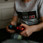 kid sitting on gray bed while playing